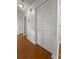 A hallway features hardwood floors and a closet with white louvered doors at 2929 Salamander Creek Ln, North Charleston, SC 29406