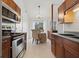 A modern kitchen is adjacent to the dining area with stainless steel appliances and dark wood cabinetry at 2929 Salamander Creek Ln, North Charleston, SC 29406
