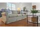 Comfortable living room featuring hardwood floors, a comfortable couch, and plenty of natural light at 2929 Salamander Creek Ln, North Charleston, SC 29406