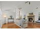 Open-concept living area with a fireplace, hardwood floors, and natural light from large windows at 2929 Salamander Creek Ln, North Charleston, SC 29406