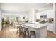 Modern kitchen with white cabinets, granite countertops, stainless steel appliances, and an island with bar stools at 310 Pine Crest View Dr, Summerville, SC 29486