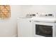 A well-lit laundry room with white front-loading washer and dryer, ready for your convenience at 311 Pine Crest View Dr, Summerville, SC 29486