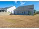 A spacious backyard featuring an outdoor seating area, well-maintained lawn, and clear view of the home at 317 Catawba Branch Way, Moncks Corner, SC 29461