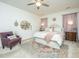 Beautiful bedroom featuring a plush bed, ceiling fan, an accent chair, and charming decor at 317 Catawba Branch Way, Moncks Corner, SC 29461