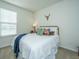 Cozy bedroom with neutral walls, decorative pillows, gold bed frame, and ample natural light at 317 Catawba Branch Way, Moncks Corner, SC 29461