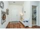 Bright foyer with hardwood floors, a decorative bench, and a view leading to a home office at 317 Catawba Branch Way, Moncks Corner, SC 29461