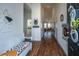 Inviting foyer featuring hardwood floors, a bench with accent pillows, and stylish decorative wall art at 317 Catawba Branch Way, Moncks Corner, SC 29461