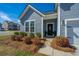 Charming front entrance featuring a decorated door, manicured landscaping and inviting entryway at 317 Catawba Branch Way, Moncks Corner, SC 29461