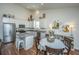 Eat-in kitchen featuring stainless steel appliances, granite counters, and center island with breakfast bar seating at 317 Catawba Branch Way, Moncks Corner, SC 29461