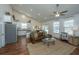 Cozy living room featuring hardwood floors, a comfortable leather couch, and an open view to the kitchen at 317 Catawba Branch Way, Moncks Corner, SC 29461