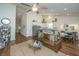 Open-concept living area featuring hardwood floors, a leather couch, and a seamless transition to the kitchen at 317 Catawba Branch Way, Moncks Corner, SC 29461