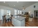 Bright eat-in kitchen, granite island, with view into adjacent living space at 317 Catawba Branch Way, Moncks Corner, SC 29461