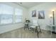 Bright home office with a glass desk, comfortable chair, and ample natural light at 317 Catawba Branch Way, Moncks Corner, SC 29461