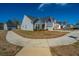 Pleasant neighborhood street view featuring sidewalks and meticulously maintained homes with lush landscaping at 317 Catawba Branch Way, Moncks Corner, SC 29461