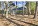 Secluded back exterior of home with mature trees and screened porch at 3334 Cottonfield Dr, Mount Pleasant, SC 29466