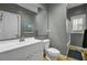 Bathroom with a white sink vanity, toilet, large mirror and a walk-in shower with hardwood floors at 3334 Cottonfield Dr, Mount Pleasant, SC 29466
