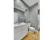 Bathroom features a white sink vanity, toilet, large mirror, and walk-in shower, with hardwood floors at 3334 Cottonfield Dr, Mount Pleasant, SC 29466