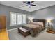 Bedroom featuring a large window, gray walls, a ceiling fan, and a full sized bed with a brown comforter at 3334 Cottonfield Dr, Mount Pleasant, SC 29466