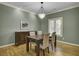 Elegant dining room with hardwood floors, classic lighting fixture, and a dark wood dining set at 3334 Cottonfield Dr, Mount Pleasant, SC 29466