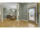 Inviting dining room with hardwood floors, decorative lighting, and a doorway leading to the main entrance at 3334 Cottonfield Dr, Mount Pleasant, SC 29466