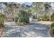 Large driveway leading to the home, complemented by well-maintained landscaping and a partial privacy fence at 3334 Cottonfield Dr, Mount Pleasant, SC 29466