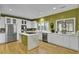 Modern kitchen with white cabinets, stainless steel appliances, and an island with a cooktop at 3334 Cottonfield Dr, Mount Pleasant, SC 29466
