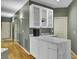 Modern kitchenette with marble countertops, white cabinets, and hardwood floors at 3334 Cottonfield Dr, Mount Pleasant, SC 29466