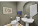 Powder room with striped wallpaper, a white sink, a toilet, and an ornate mirror at 3334 Cottonfield Dr, Mount Pleasant, SC 29466