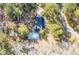 Aerial view of the home with a spacious yard, swimming pool, and surrounding trees at 405 Huntington Rd, Summerville, SC 29483