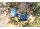 Aerial view of the home with a swimming pool, patio, and driveway nestled among lush trees at 405 Huntington Rd, Summerville, SC 29483
