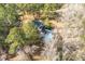 Aerial view showcasing the home with an in-ground pool surrounded by mature trees at 405 Huntington Rd, Summerville, SC 29483