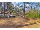 Vast backyard featuring a brick home, shed, and a boat offering ample space for outdoor activities at 405 Huntington Rd, Summerville, SC 29483