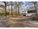 Large backyard with mature trees, outbuilding, and boat, offering privacy and room to roam at 405 Huntington Rd, Summerville, SC 29483