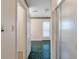 Hallway leading to bathroom and exterior, bright with green tile flooring at 405 Huntington Rd, Summerville, SC 29483