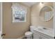 Cozy half-bathroom featuring a round mirror, white fixtures, and natural light at 405 Huntington Rd, Summerville, SC 29483