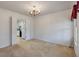 Bright dining room with chandelier leads to kitchen with white cabinetry and modern appliances at 405 Huntington Rd, Summerville, SC 29483