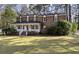 Charming brick home with a welcoming front porch and well-manicured lawn, perfect for Gathering living at 405 Huntington Rd, Summerville, SC 29483
