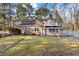 Well-maintained backyard view of brick home with covered porch and balcony, near the pool and lawn at 405 Huntington Rd, Summerville, SC 29483