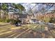 A view of a two-story brick home with a screened-in porch and a balcony overlooking the yard at 405 Huntington Rd, Summerville, SC 29483