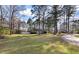 Expansive front yard with mature trees providing shade and privacy to the beautiful home at 405 Huntington Rd, Summerville, SC 29483