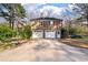 Large detached two-car garage with an overhead basketball hoop on an expansive driveway at 405 Huntington Rd, Summerville, SC 29483