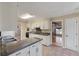 The kitchen features tile floors, white cabinetry and breakfast bar at 405 Huntington Rd, Summerville, SC 29483
