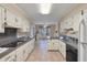 Well-lit kitchen with white cabinets, tile floors, and black appliances for a clean design at 405 Huntington Rd, Summerville, SC 29483