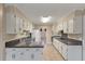 Spacious kitchen features white cabinetry and black appliances at 405 Huntington Rd, Summerville, SC 29483