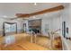 Sun-lit living room boasts hardwood floors, brick fireplace, and natural wood beam ceiling at 405 Huntington Rd, Summerville, SC 29483