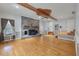 Inviting living room with hardwood floors, brick fireplace, and natural wood beam ceiling at 405 Huntington Rd, Summerville, SC 29483