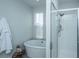 Bright bathroom features a tub, stand up shower, tiled floors, and single window at 411 Watergrass Way, Summerville, SC 29485