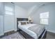 Bedroom with wood floors, queen size bed, white walls, rug, and large window at 411 Watergrass Way, Summerville, SC 29485