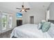 Bright bedroom features a ceiling fan, television, wood floors and french doors to the outside at 411 Watergrass Way, Summerville, SC 29485