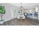Bright dining area with modern table, chairs, and view into kitchen and outdoor space at 411 Watergrass Way, Summerville, SC 29485
